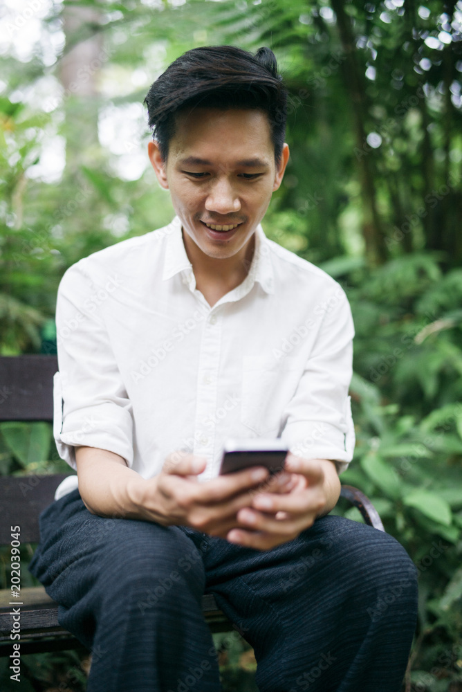 Fototapeta premium Thai man with smartphone