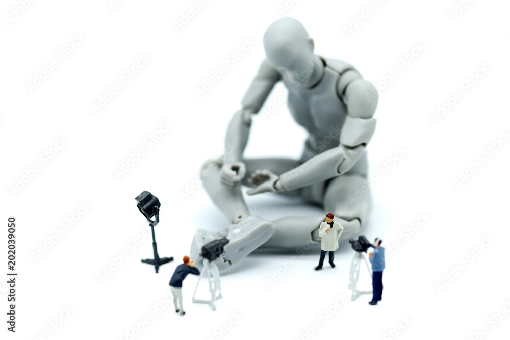 Miniature people : journalists , cameraman ,Videographer at work shooting on Model robot action,production concept. Miniature people : journalists , cameraman ,Videographer at work shooting on Model robot action,production concept.