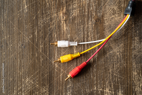 Audio-video analog cable on wooden background with copy-space photo