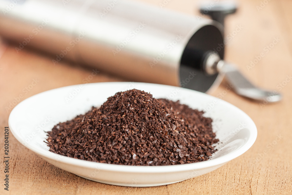 Coffee powder in white dish on wood table. Coffee powder in white dish on wood table.