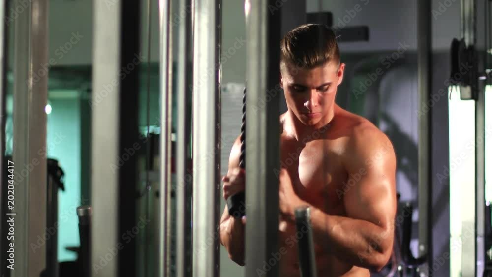 Cute man exercising triceps at gym Cute man exercising triceps at gym