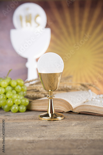 Eucharist symbol of bread and wine, chalice and host, First communion background