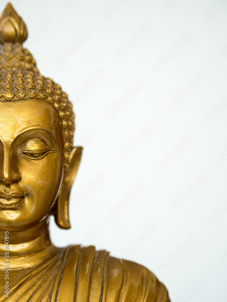 The part of face golden antique buddha statue on the white background (isolated background). The face of the Buddha is Straight face. copy space for text and content