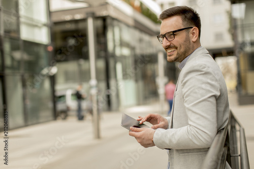 Portrait of a young businessman holding digital tablet