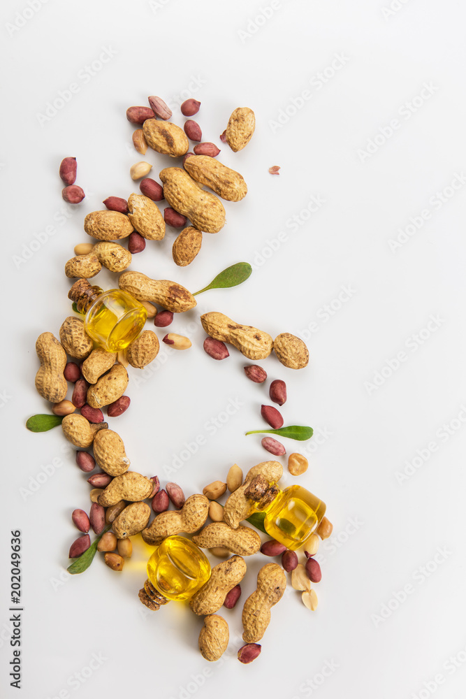 Natural peanut butter with oil in a glass jar and peanuts Natural peanut butter with oil in a glass jar and peanuts