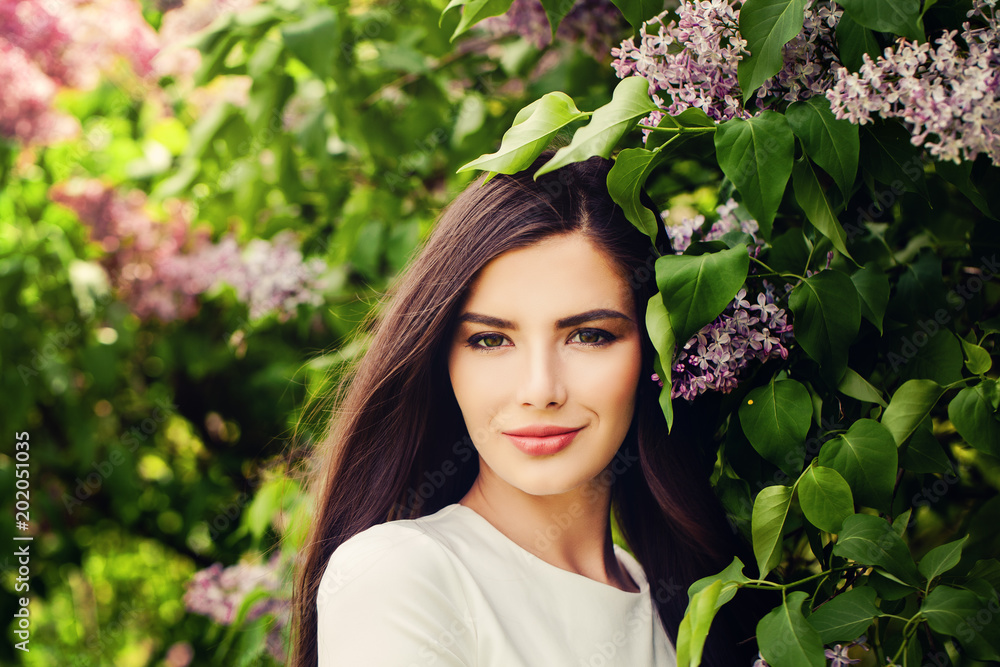 Beautiful brunette woman with healthy brown hair and natural makeup on summer background outdoors Beautiful brunette woman with healthy brown hair and natural makeup on summer background outdoors