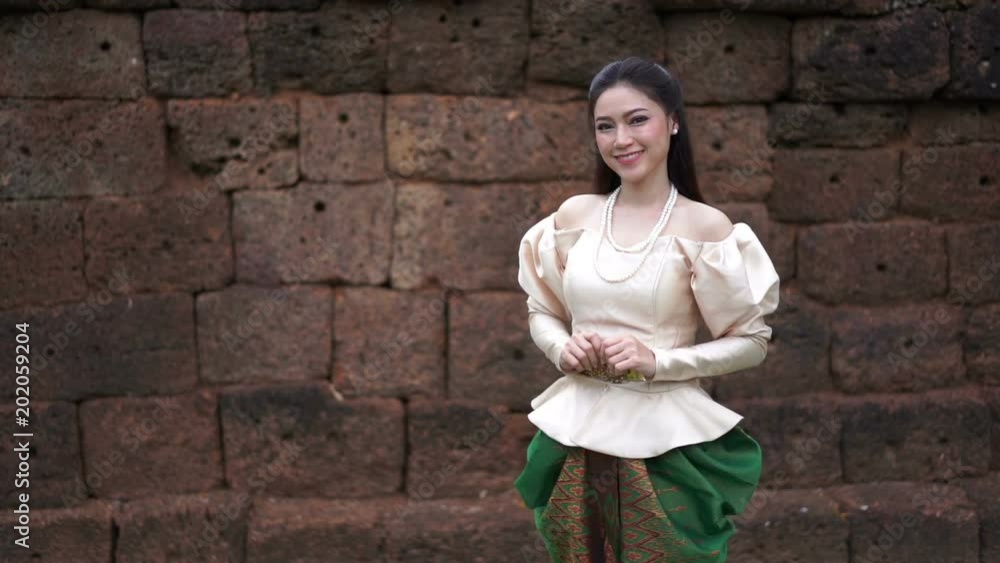 slow motion of happy beautiful woman in Thai traditional dress slow motion of happy beautiful woman in Thai traditional dress