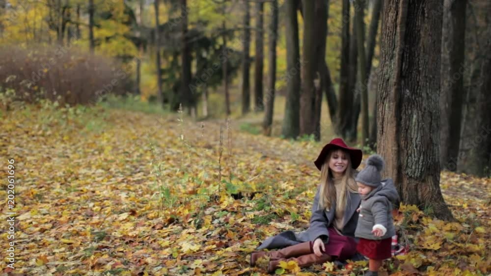 stylish mommy with daughter in autumn park stylish mommy with daughter in autumn park