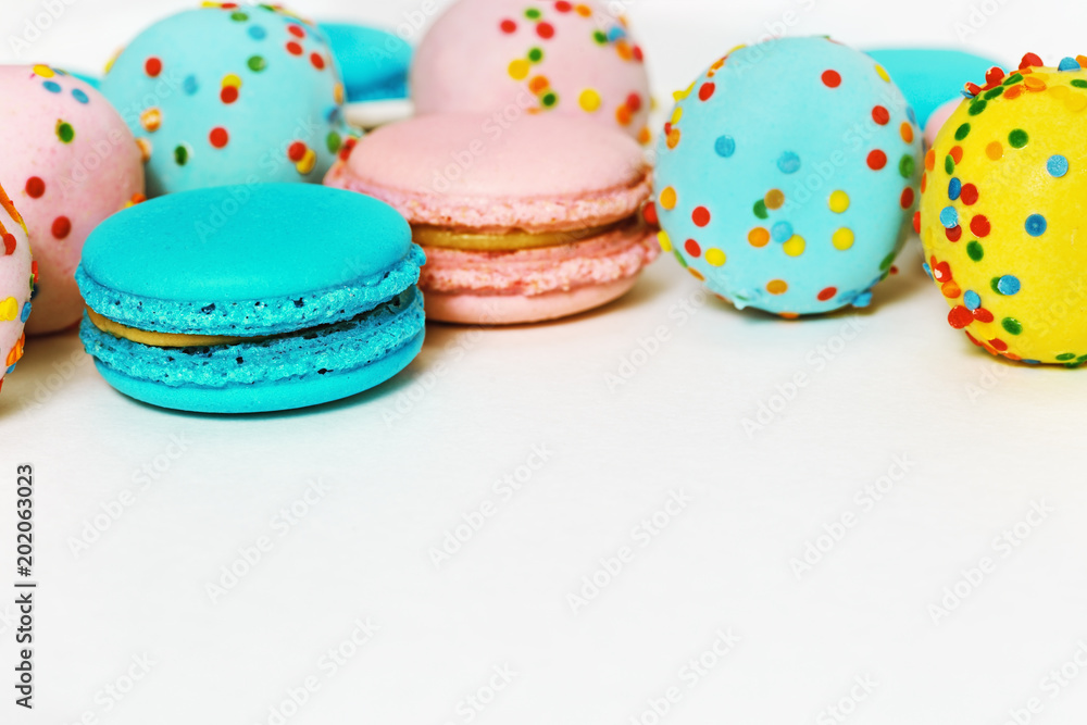 Pink and mint green macaroons and colorful cake pops. Delicious multi-colored almond cookies as background. Copy space. Selective focus. Pink and mint green macaroons and colorful cake pops. Delicious multi-colored almond cookies as background. Copy space. Selective focus.