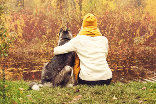 Dog and Girl hugging Outdoors. Happiness