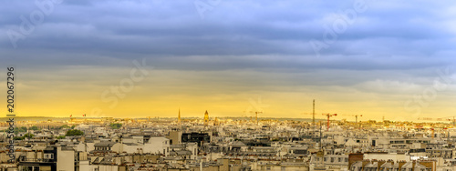 Aerial panorama of Paris skyline over roofs at sunset