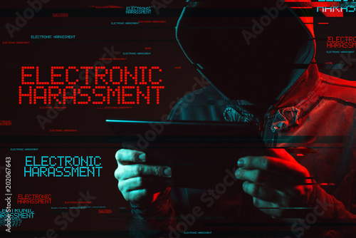 Electronic harassment concept with faceless hooded male person photo