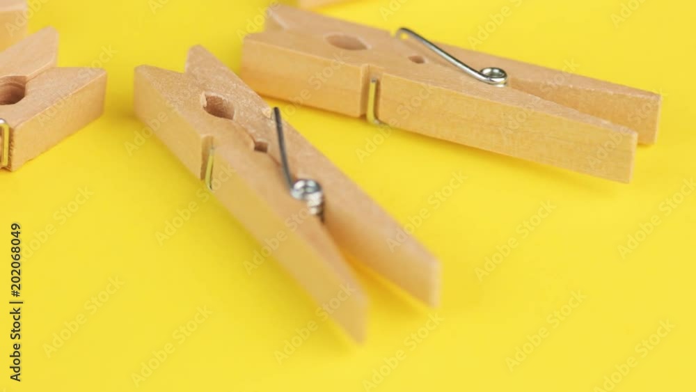 Wood Natural Bamboo Clothespins on Yellow Background. Wood Natural Bamboo Clothespins on Yellow Background.