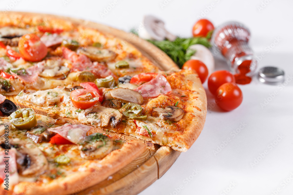 Italian kitchen and cooking concept. Hot tasty sliced with ham, sausage, jalapenos, mushrooms, tomato. Eat delivery concept. Italian kitchen and cooking concept. Hot tasty sliced with ham, sausage, jalapenos, mushrooms, tomato. Eat delivery concept.
