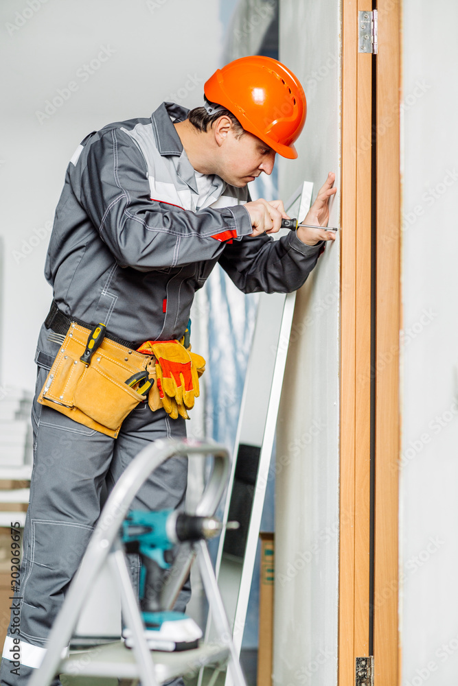 Worker with electrical screwdriver. Repair and building concept. Worker with electrical screwdriver. Repair and building concept.