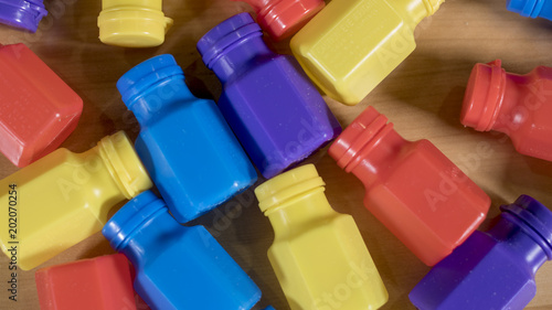 A mess of various beautifully colored containers for liquids