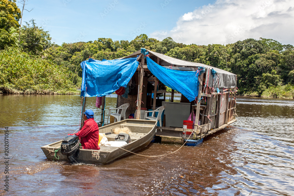 Jungleboat: rustikales  selbstgebautes Hausboot / Floß aus Fässern und Planen auf dem Amazonas