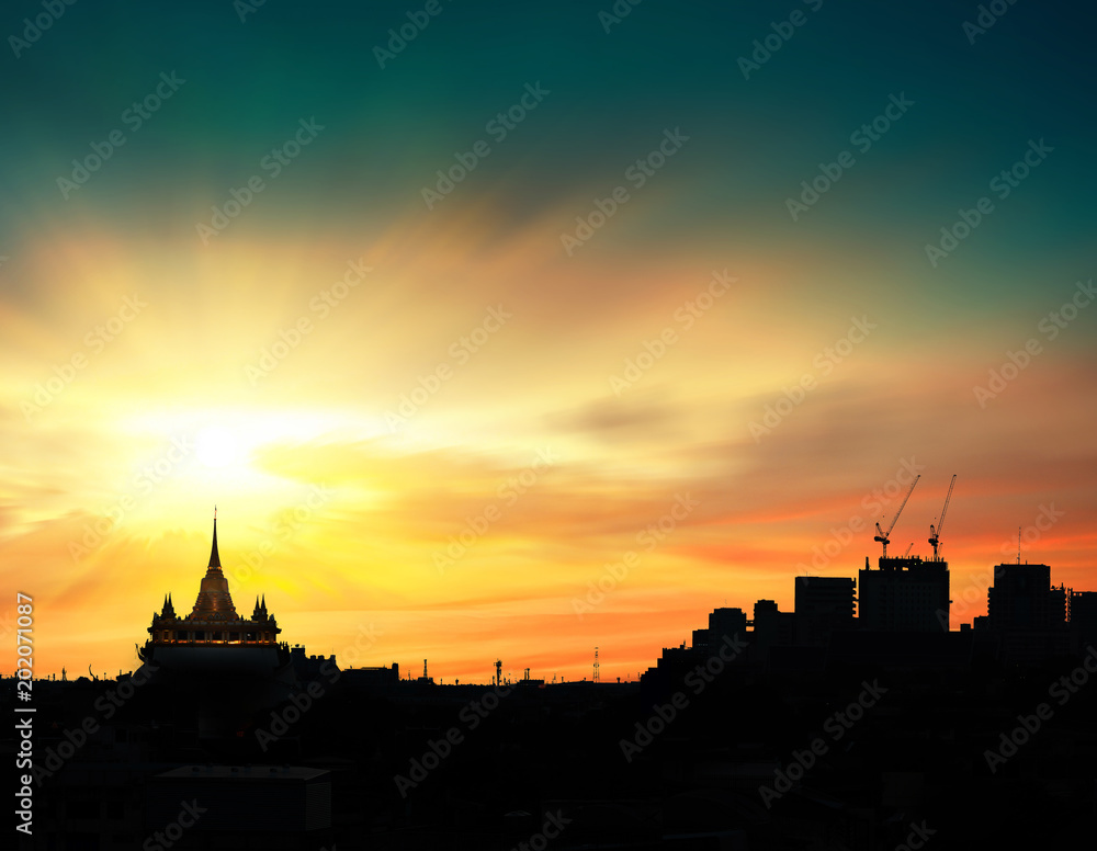 Silhouette of the temple and the city of evening time with beautiful sky light