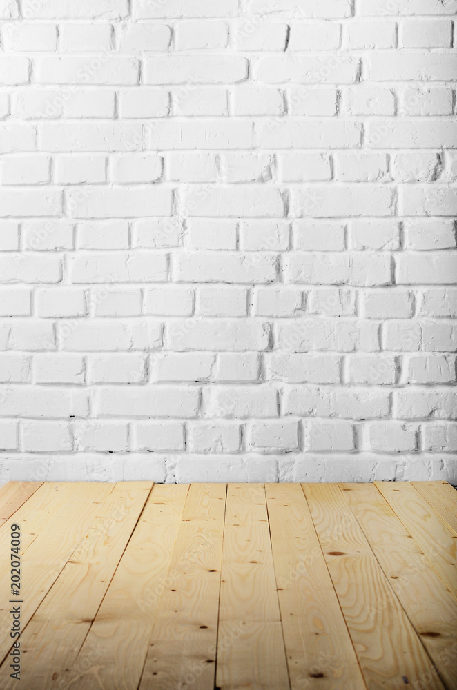 White brick wall of painted genuine clay blocks and wooden floor background White brick wall of painted genuine clay blocks and wooden floor background