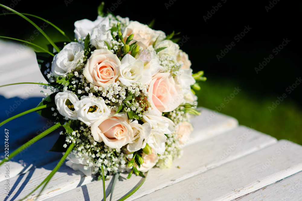 Bouquet of a bride on a white bench. Beautiful wedding bouquet. 