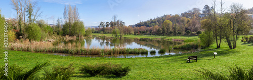 Parque da Devesa Urban Park in Vila Nova de Famalicao, Portugal. Built near the center of the city. View of the green grass lawns and lake or pond photo