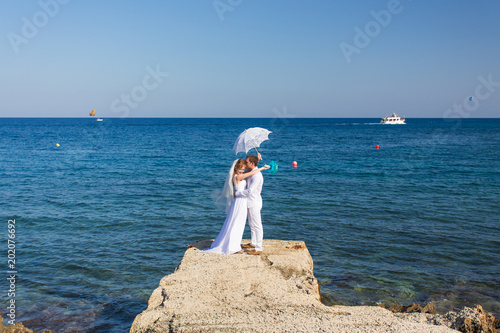 Bride and groom by the sea on their wedding day