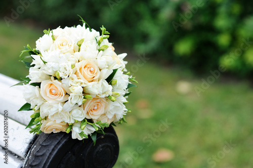 Bouquet of a bride on a white bench. Beautiful wedding bouquet. 