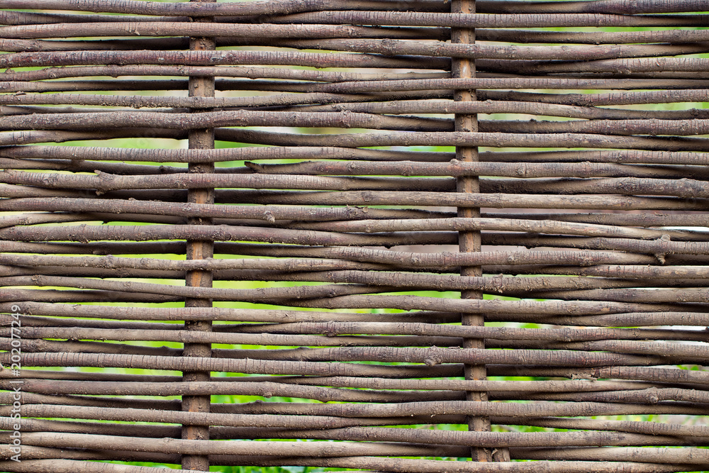 Wooden brown texture of thin rural fence rods Wooden brown texture of thin rural fence rods