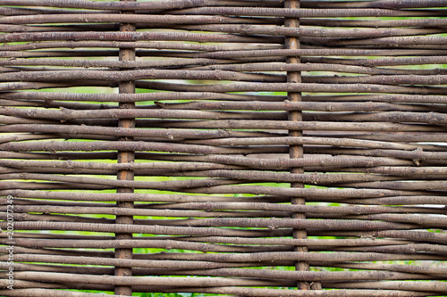 Wooden brown texture of thin rural fence rods