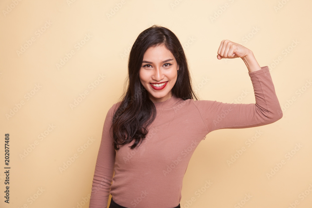 Beautiful young Asian woman flex bicep. Beautiful young Asian woman flex bicep.