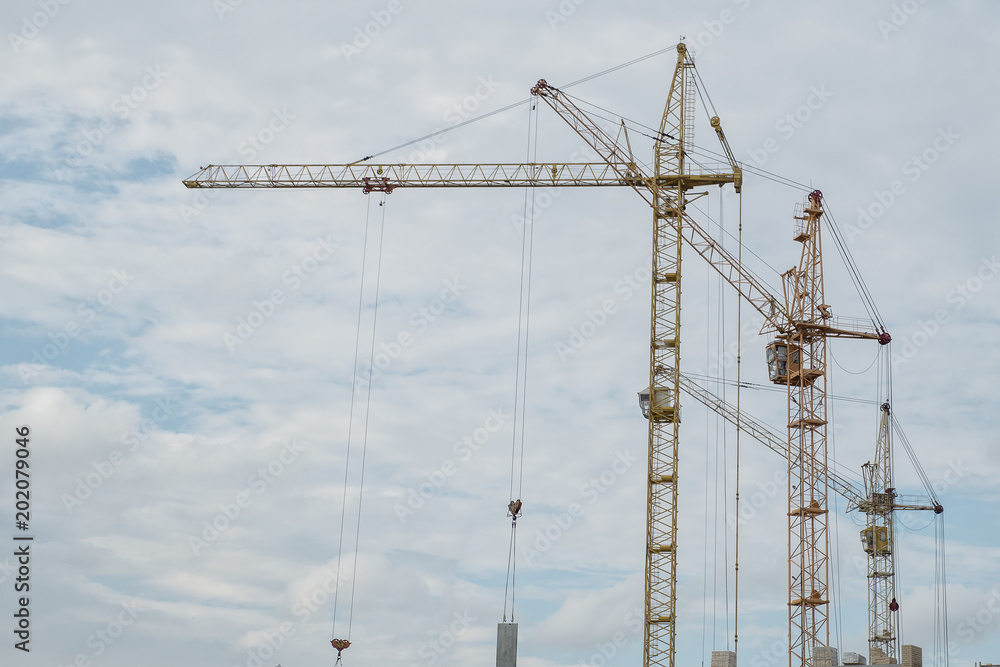 Construction cranes against the sky, new high-rise buildings Construction cranes against the sky, new high-rise buildings