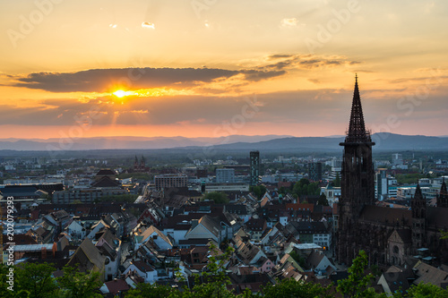 Germany, Warm orange evening sunlight on the roofs of City Freiburg im Breisgau from above