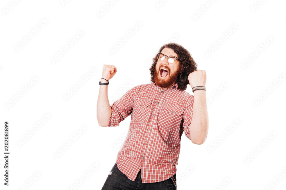 Excited bearded man with eye glasses celebrating victory Excited bearded man with eye glasses celebrating victory