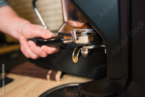 Making coffee in machine in cafe