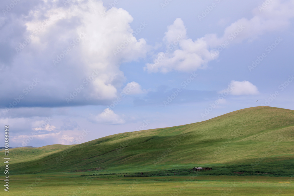 green hills under blue sky