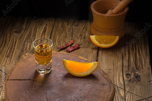 Mezcal shot mexican drink with orange slices, chili and worm salt in oaxaca mexico photo