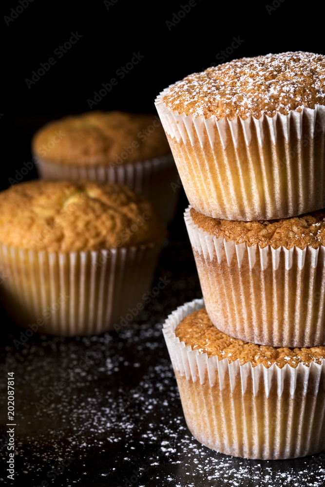 Muffins sprinkled with the powder sugar Muffins sprinkled with the powder sugar
