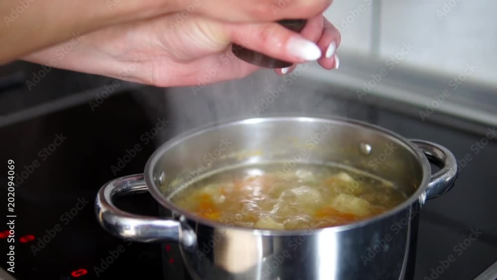 black peper spice adding to knoodle soup, slow motion, cinematic dof black peper spice adding to knoodle soup, slow motion, cinematic dof