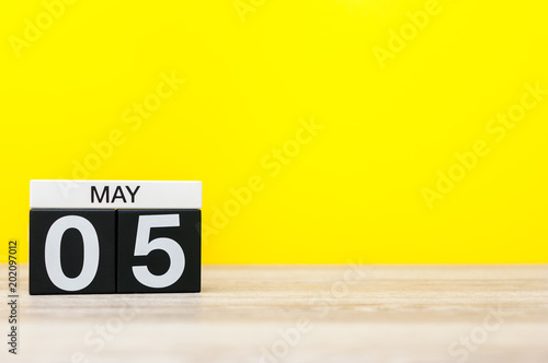 May 5th. Day 5 of may month, calendar on yellow background. Spring time, empty space for text