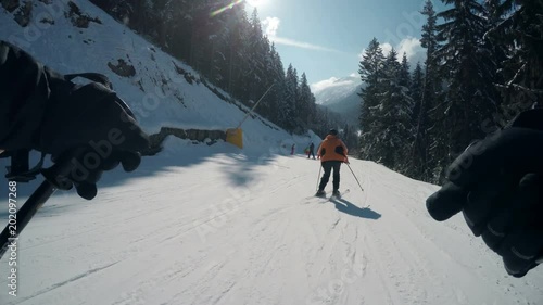 Winter pov of people skiing on slope of famous ski resort Bansko photo