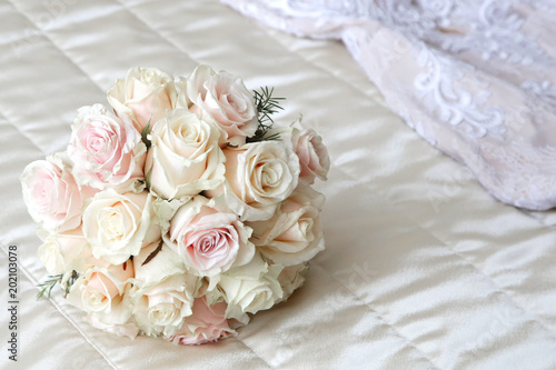  Beautiful roses bouquet laying on the bed