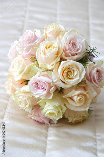   Beautiful roses bouquet laying on the bed