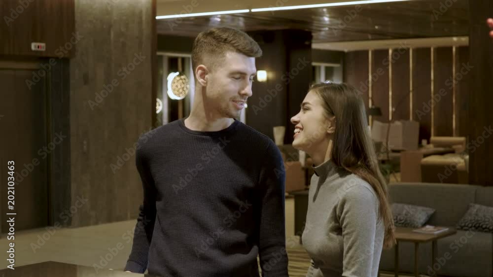 Close-up shot of happy family couple checking in at the receptionist in lobby cozy interior of luxury hotel. 4K Close-up shot of happy family couple checking in at the receptionist in lobby cozy interior of luxury hotel. 4K