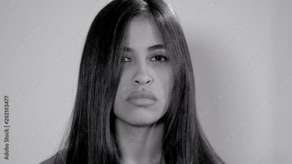 Sad hispanic female model unhappy closeup black and white looking camera Sad hispanic female model unhappy closeup black and white looking camera