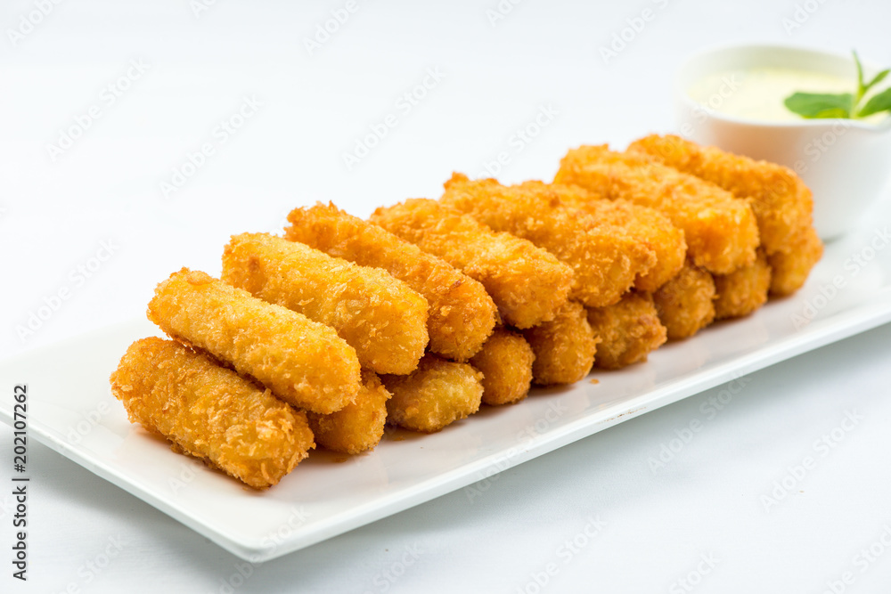 Meat fried in batter with dill in squared plate over white background Meat fried in batter with dill in squared plate over white background