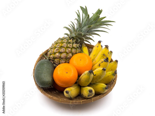 Fresh mixed fruits in basket on a white background