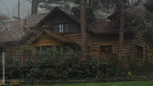 Zoom-in on rustic lodge in the rain near Grants Pass, Oregon