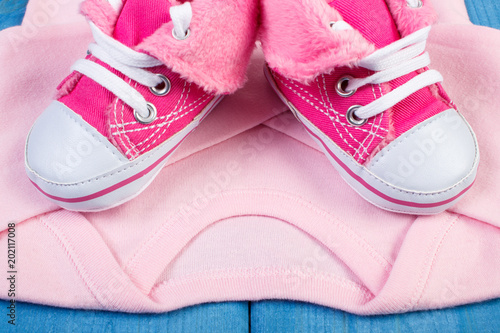 Shoes and bodysuits for newborn  expecting for baby concept