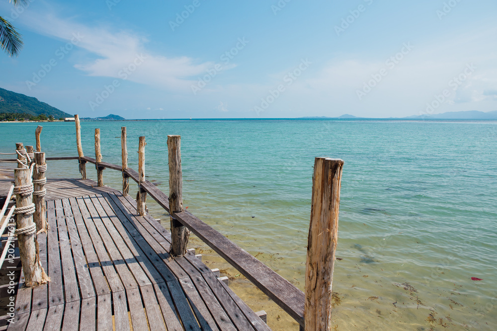 Paradise beach with wooden bridge