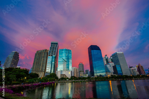 Beautiful Benchakitti Park near the skyscraper business district View Bangkok city with park at twilght with reflection of skyline Thailand